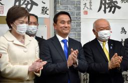 　山口県知事選で３選を確実にし、笑顔を見せる村岡嗣政氏（中央）＝６日夜、山口市