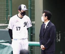 　キャンプの視察に訪れた日本代表の栗山監督（右）と話すロッテ・佐々木朗＝石垣