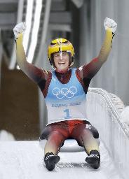 　女子１人乗りで五輪３連覇を達成し、ガッツポーズするドイツのナタリー・ガイゼンベルガー＝２月８日、延慶（共同）