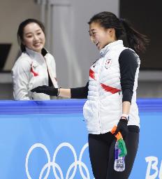 　１２日、練習を終え笑顔を見せる坂本花織。左は樋口新葉＝北京（共同）