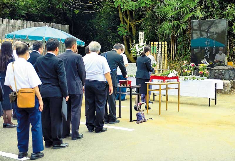 追悼慰霊碑の前で焼香や献花を行う参列者＝６日、野田市三ツ堀