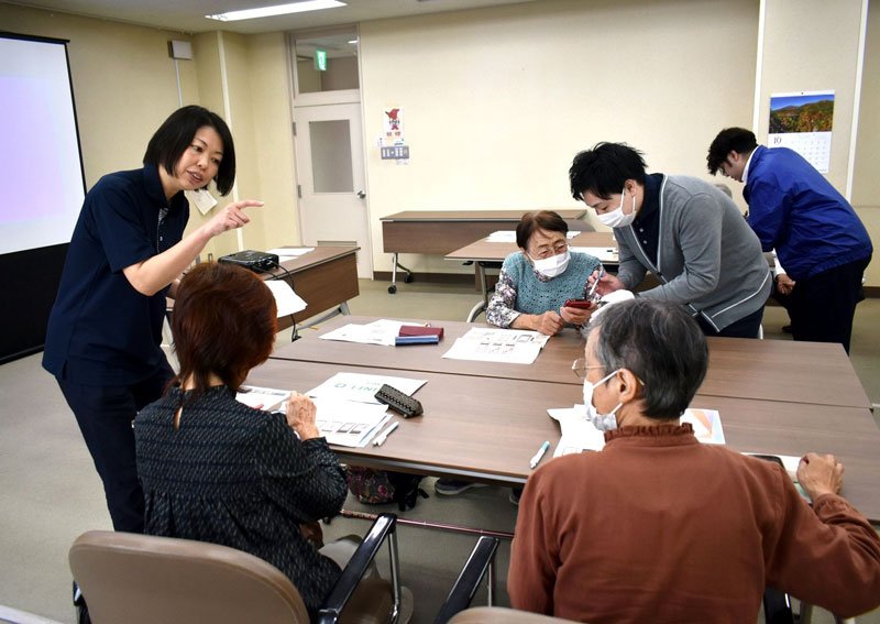 スマートフォンの使い方について教える菊池さん（左）＝多古町コミュニティプラザ