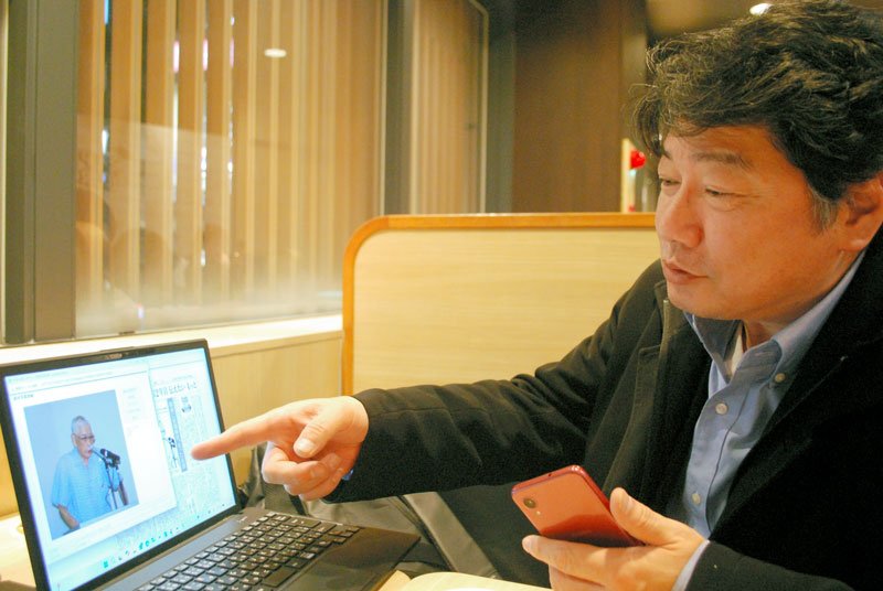 長崎で原爆を体験した父・朝太郎さんの写真を指さしながら、人となりを話す息子の洋一さん＝１月３０日、習志野市