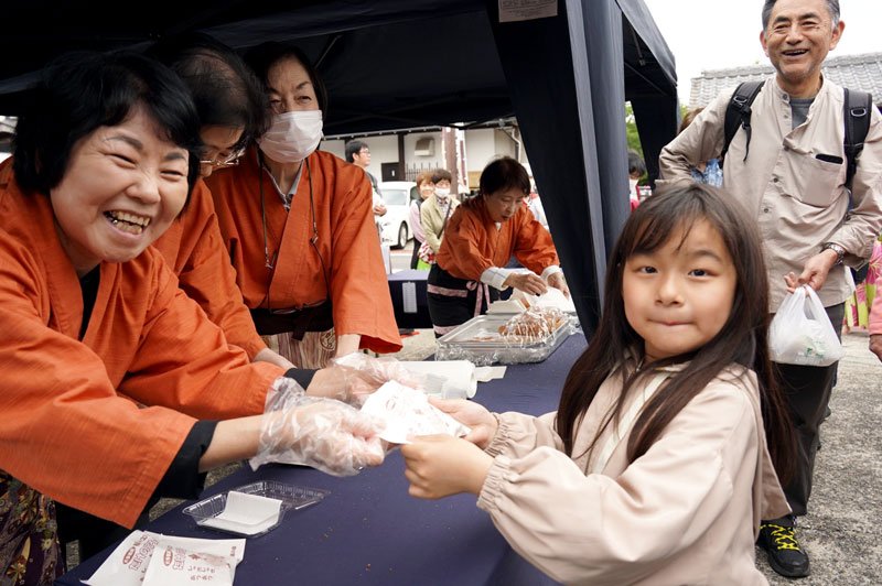 二十八市の名物「たけのころっけ」を手渡す葵の会メンバー（左）＝４月２９日、大多喜町