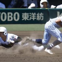 ７回裏専大松戸１死一、三塁、投前内野安打となるスクイズで一塁にヘッドスライディングする上迫田。（共同）
