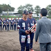 優勝トロフィーを受け取る山崎主将