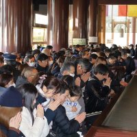 成田山新勝寺の大本堂で祈りを込めて手を合わせる初詣客＝１日午前、成田市